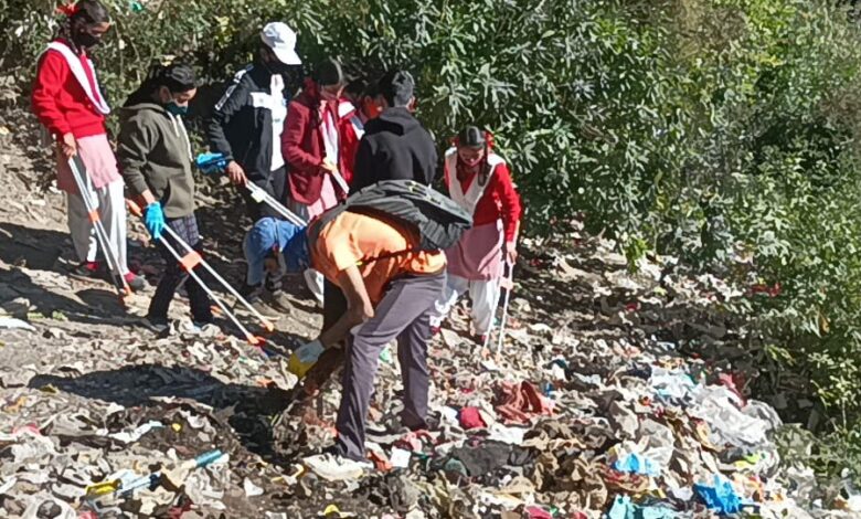 Volunteers cleaning hill slopes of Mussoorie on international mountain day on Saturday.